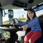 A girl enjoys a ride on a tractor at Countryside Lincs