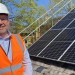 Cllr Wright with Solar panels at NKDC.
