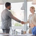 Handshake, applause and team of business people meeting for partnership, deal or agreement in office. Happy group clapping for collaboration, shaking hands and b2b integration, acquisition or success