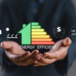 Energy efficiency concept. Person holding energy efficiency rating icon on virtual screen for energy efficient house building rate label audit.